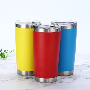 Three 20oz vacuum insulated tumblers in red, yellow and blue on a marble surface