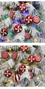 Close-up of red candy-shaped Christmas ornaments with white glitter on snowy tree branches