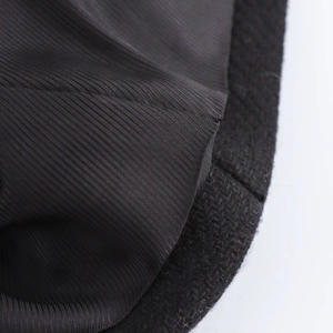 Macro detail of high-quality black wool coat fabric with pinstripe lining texture