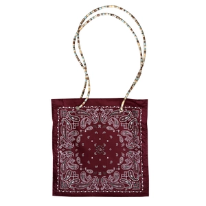 Deep red paisley tote bag with unique colorful beaded woven strap on a white background