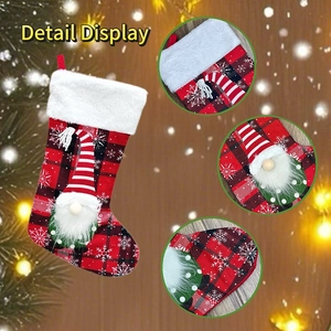 Detail view of plaid Christmas stocking featuring a gnome doll with white faux fur trim