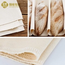 Macro detail of thick cotton proofing cloth with edge stitching for artisan bread baking