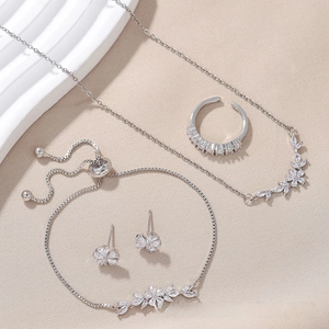 Detailed view of silver heart jewelry set with necklace bracelet and zirconia stones
