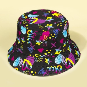 Close-up of black bucket hat featuring vibrant graffiti prints like stars and hearts