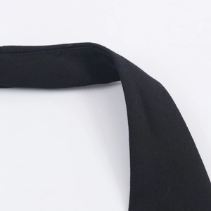 Close-up of the elegant halter neckline and fine fabric texture on the black waistcoat