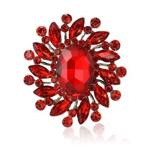 Vintage red rhinestone brooch with central crystal in a radiant sunburst gold alloy setting
