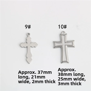 Detail view of two silver cross pendants with vintage engraving and double-layered frame