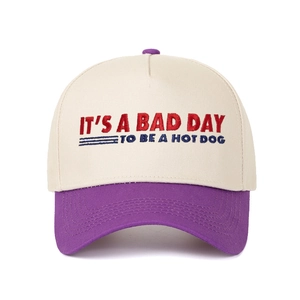 Close-up of contrast-color cap with 'It's a Bad Day to Be a Hotdog' embroidery detail