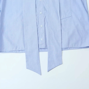 Women's light blue casual shirt featuring a bow-tie neck design and white buttons