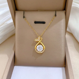 Elegant gold fishtail necklace with large round zircon and accent diamonds in a gift box