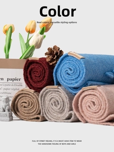 Close-up of soft knitted scarves in five colors featuring premium leather label details