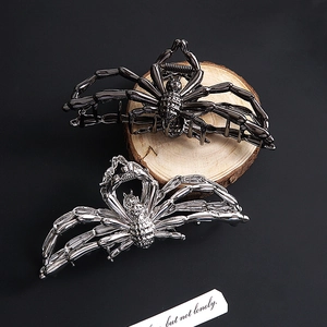 Halloween spider metal hair claw clip in silver and gun black finishes on wood