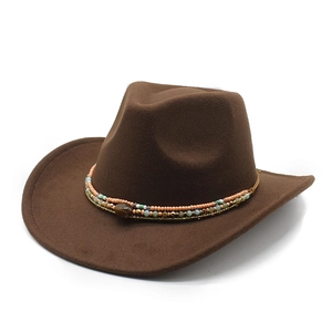 Detail of brown felt cowboy hat with colorful beaded band and decorative stone accent