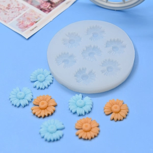 Detail of blue daisy silicone mold with finished resin flower pieces for DIY crafts