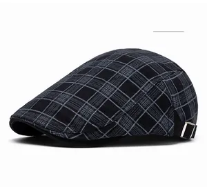 Detail of black plaid flat cap showing cotton texture and side metal adjustable buckle