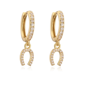 Luxury gold horseshoe U-shaped earrings with clear zircon stones on a white background