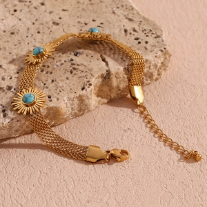 Detail of 18K gold-plated mesh chain bracelet with turquoise sunflower and lobster clasp