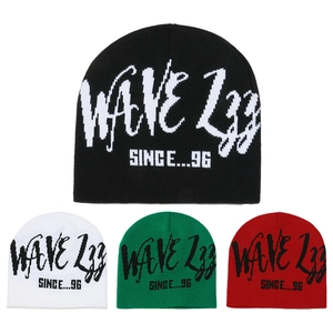 Detail view of four color options of a knitted beanie featuring letter jacquard design