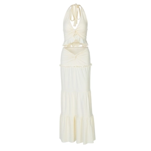 Detail of cream white two-piece set featuring a knot front crop top and ruffled maxi skirt