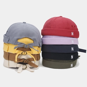 Detailed close-up of retro miki hat with side N embroidery and adjustable metal buckle