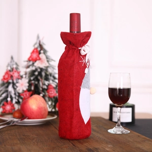 Christmas wine bottle cover with snowflake embroidery on wooden table background