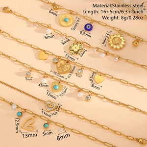 Gold stainless steel paperclip chain bracelets with bohemian charms and evil eye details