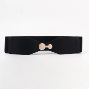 Detail of a wide black elastic belt featuring a polished gold circular metal buckle