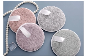 Flat lay of soft bamboo charcoal fiber makeup remover pads in pink and grey tones
