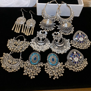 Detailed set of Bohemian ethnic earrings with intricate silver metalwork and blue gemstones