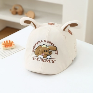 Detail of baby beige beret featuring 3D ears and cute brown puppy cartoon print