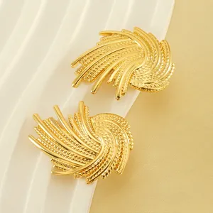 Exaggerated gold stainless steel swirl earrings with granular texture and retro style
