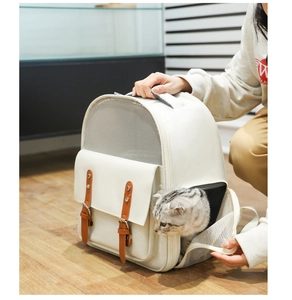 Detail of breathable cream leather pet carrier with mesh and brown leather straps