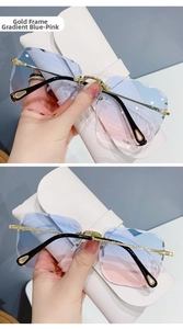 Detail of rimless gradient blue-pink sunglasses with golden hollow water drop temple tips