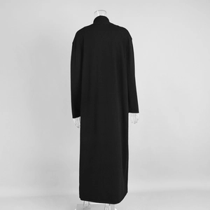 Macro detail of the high neck and smooth knit texture on the back of the black maxi dress