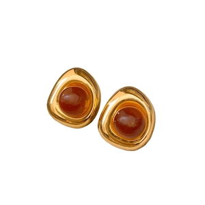 Retro irregular gold hoop earrings with brown resin stone on white background