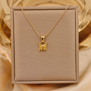 Detail of 18K gold-plated butterfly necklace with yellow zircon on silk and jewelry box