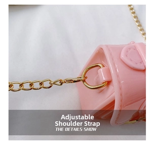Close-up of pink mini bag with gold chain strap connector and metallic buckle detail
