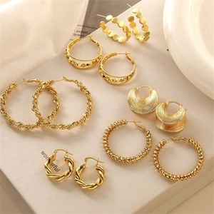 Detail of 18K gold-plated earring set featuring twisted hoops and geometric textures