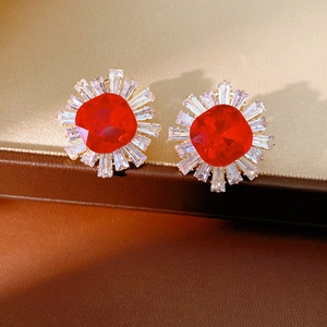 Macro detail of vintage floral earrings with red square crystal and zircon accents