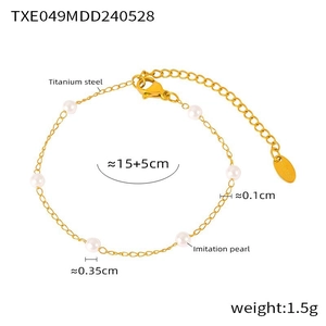 Detail of gold-plated titanium steel bracelet featuring delicate imitation pearls on white background
