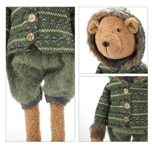 Detail of a Christmas bear plush in green knit sweater with wooden buttons and soft textures