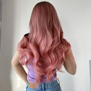 Detailed back view of long wavy synthetic hair in gradient rose gold pink hair extensions