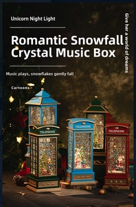 Detail of Christmas telephone booth snow globe with light and music in festive setting