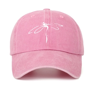 Close-up of pink washed cotton baseball cap featuring a white dragonfly print detail