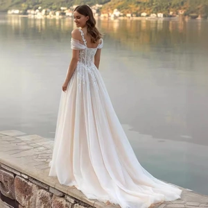 Elegant off-shoulder A-line wedding dress with lace embroidery and a long tulle train