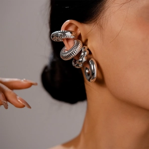 Macro shot of silver textured ear cuff set including ribbed and twisted metal designs