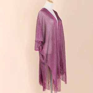 Detail of purple knit shawl with shimmer finish and elegant tassel fringe on mannequin