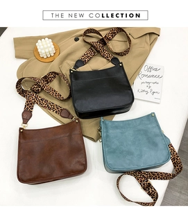 Three leather crossbody bags in black, brown and blue with leopard print wide straps
