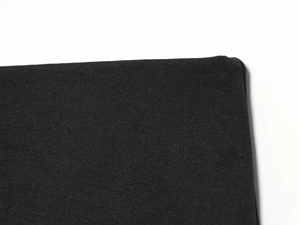 Macro shot of the premium black knitted fabric detail with rounded edge finishing