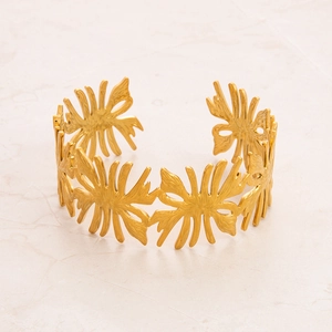 Detailed view of open 18k gold plated bangle with intricate hollow leaf and flower design